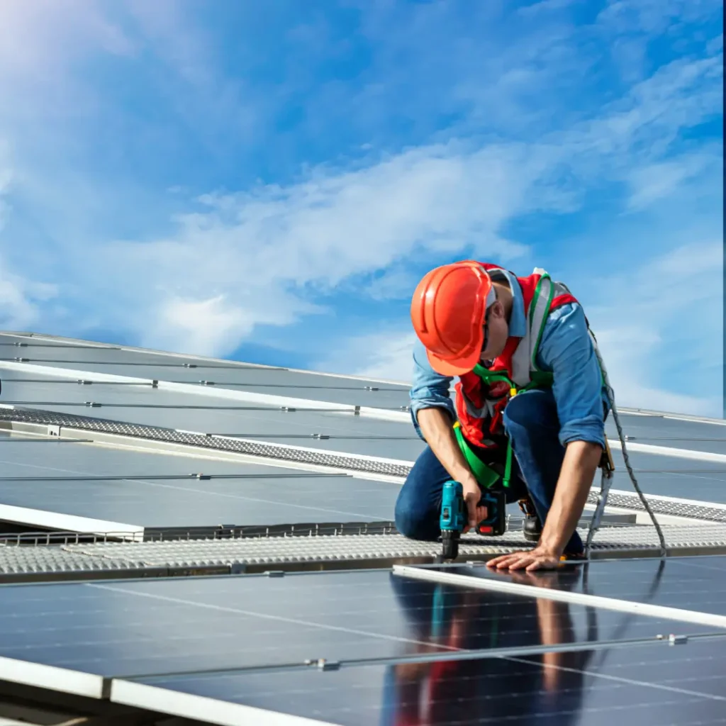 installer installing solar panels on the root